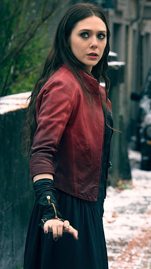 Elizabeth Olsen as Scarlet Witch in a red jacket and dark dress on a snowy street HD phone wallpaper