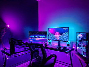Neon Purple Gaming Room with Dual Monitors and RGB PC Build HD wallpaper