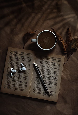 Cozy Study Flat Lay with Open Book, Coffee, and Wireless Earbuds HD phone wallpaper