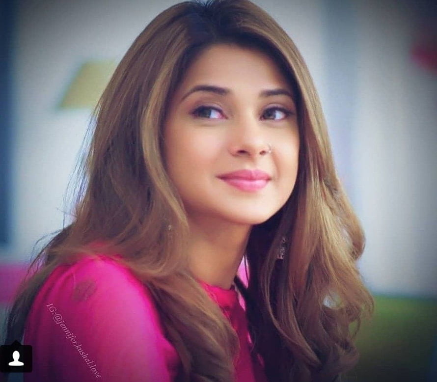 Jennifer Winget in a vibrant pink top with long wavy hair and a soft smile HD wallpaper