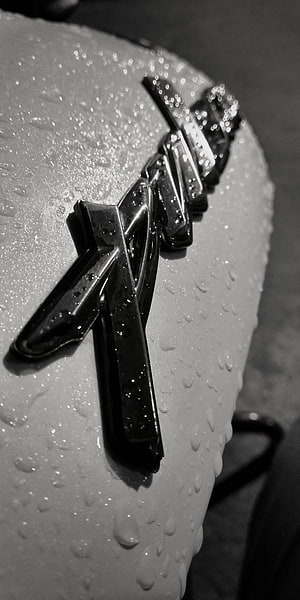 Pulsar NS200 Motorcycle Emblem Close-Up with Water Droplets in Black and White HD phone wallpaper
