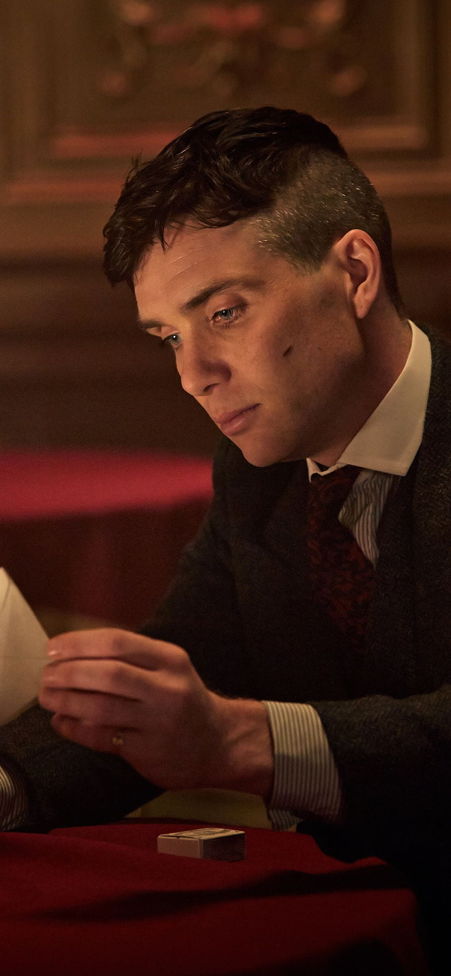 Cillian Murphy as Tommy Shelby in Peaky Blinders at a dimly lit table with a matchbox HD phone wallpaper