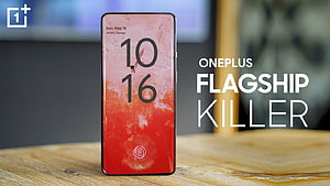 OnePlus 9RT Smartphone Displaying Vibrant Red Gradient Wallpaper on Wooden Surface HD wallpaper