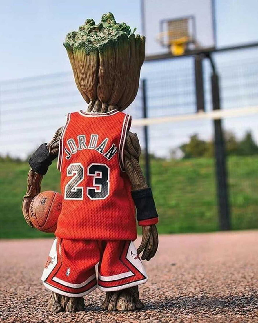 Baby Groot in a red Jordan 23 basketball jersey holding a ball on an outdoor court HD phone wallpaper
