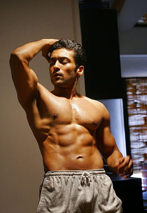 Surya shirtless portrait with defined six pack abs and athletic physique HD phone wallpaper