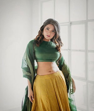 Aathmika in Green Crop Top and Yellow Lehenga Choli HD phone wallpaper