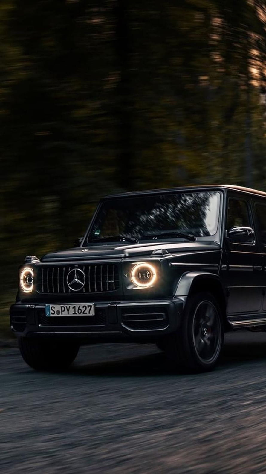 Black Mercedes-Benz G-Class SUV Driving on a Forest Road at Dusk HD phone wallpaper