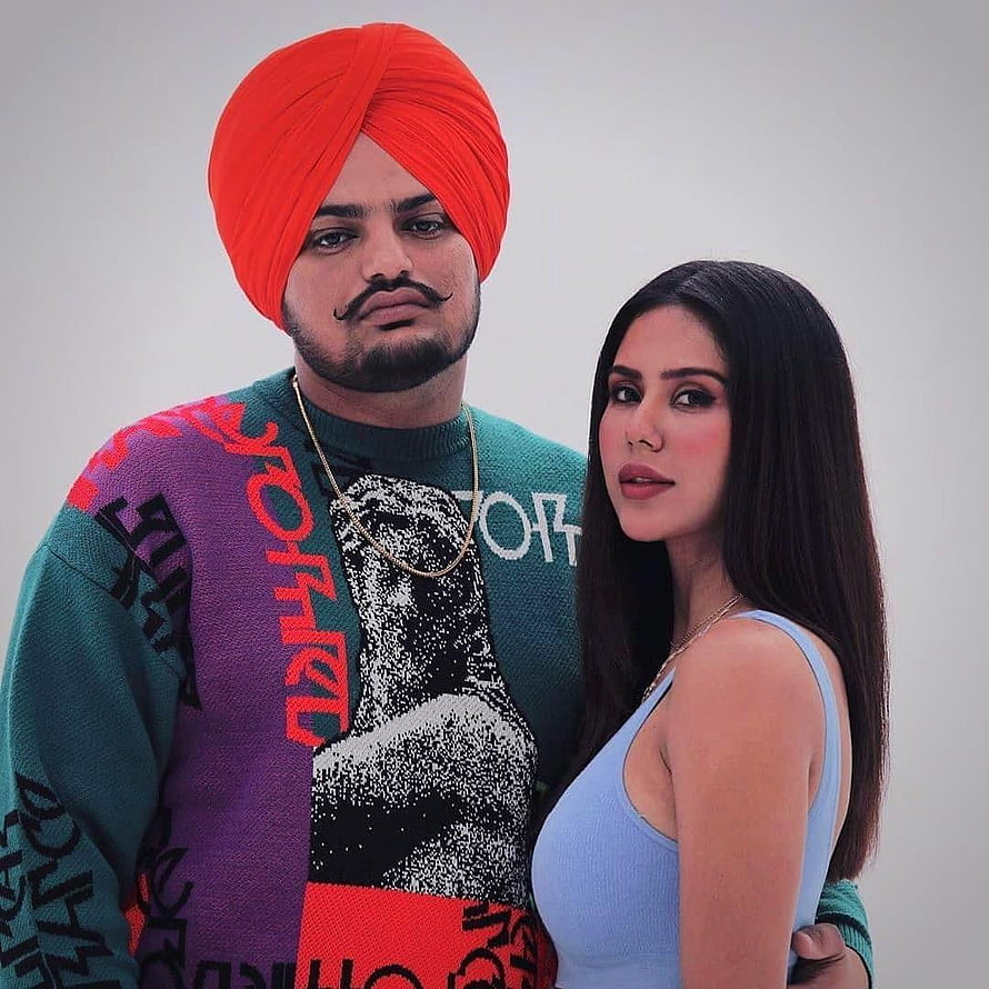 Sidhu Moose Wala and female companion in colorful studio portrait HD phone wallpaper