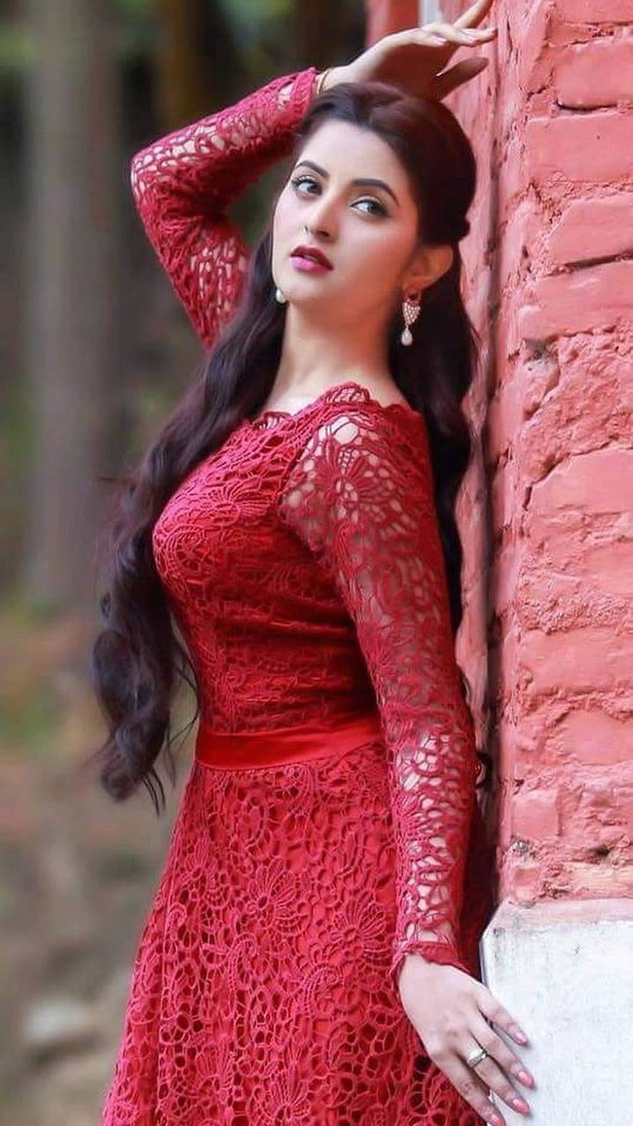 Elegant Woman in Red Lace Dress Leaning Against Brick Wall HD phone wallpaper