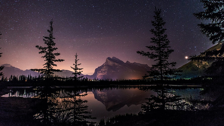 Starry Night Sky Over Mountain Lake With Pine Tree Reflections HD wallpaper
