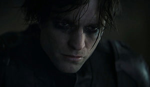 Robert Pattinson as The Batman in a Dark Cinematic Close-Up Portrait HD wallpaper