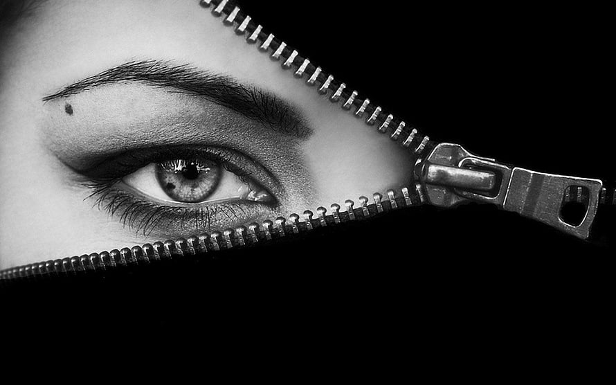 Black and White Close-Up of a Woman's Eye Peeking Through a Metal Zipper HD wallpaper