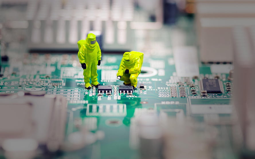 Miniature Technicians in Hazard Suits Working on a Green Circuit Board HD wallpaper