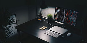 Moody Minimalist Home Office Setup With Laptop, Monitor, and Desk Lamp in Low Light HD wallpaper