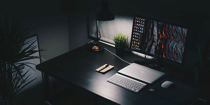 Moody Minimalist Home Office Setup With Laptop, Monitor, and Desk Lamp in Low Light HD wallpaper