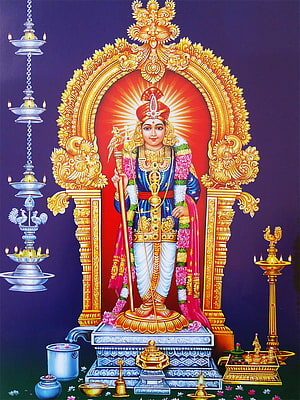 Murugan deity standing in ornate golden arch with oil lamps and ritual offerings HD phone wallpaper