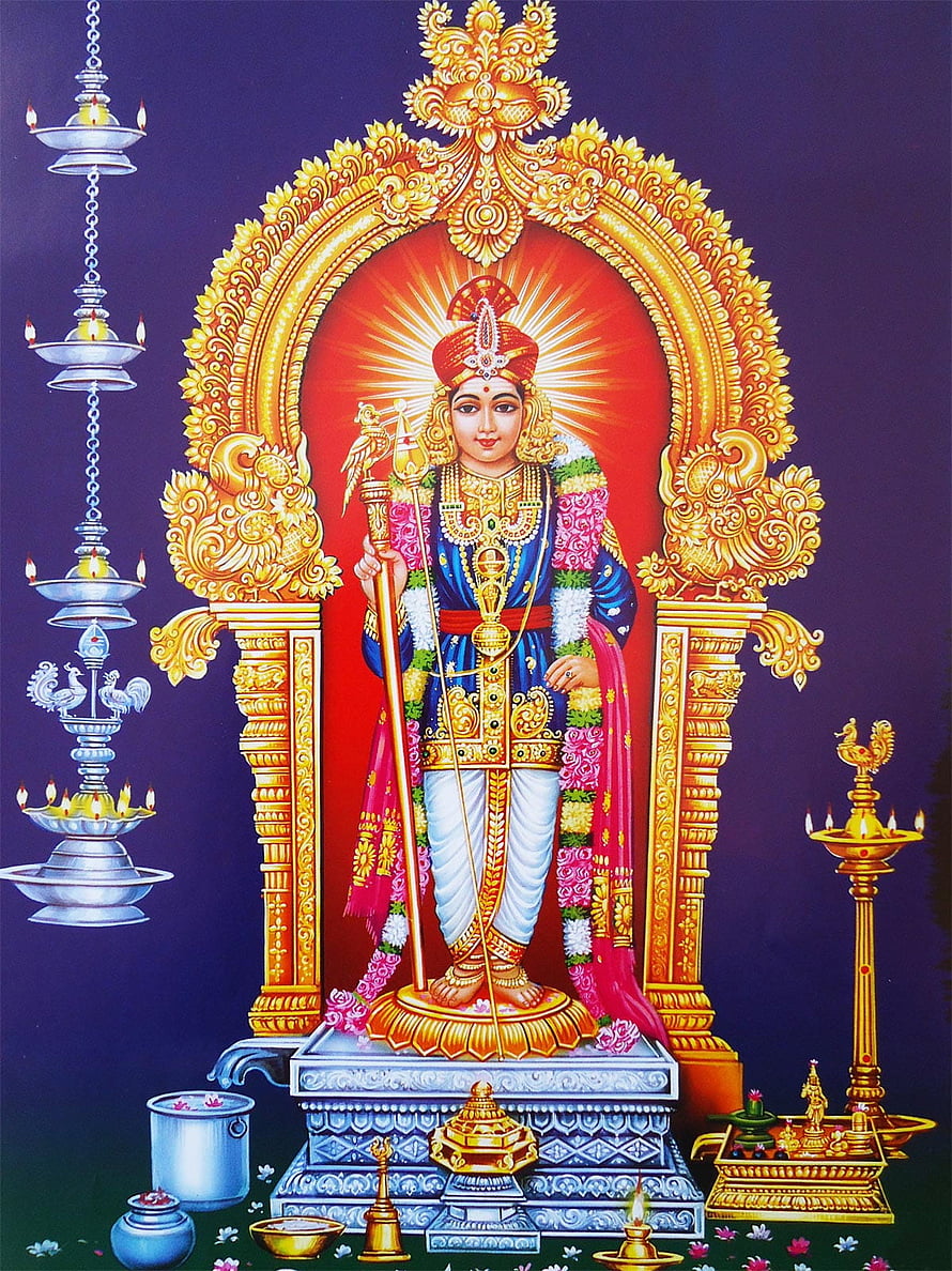 Murugan deity standing in ornate golden arch with oil lamps and ritual offerings HD phone wallpaper