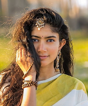 Sai Pallavi in a yellow and white saree with traditional gold jewelry and a maang tikka HD phone wallpaper