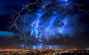 Dramatic Night Thunderstorm with Multiple Lightning Strikes Over a City Skyline HD wallpaper