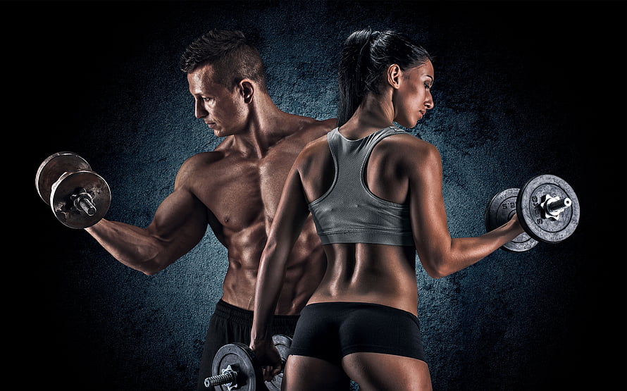 Muscular Male and Female Athletes Lifting Dumbbells in Dark Gym Setting HD wallpaper
