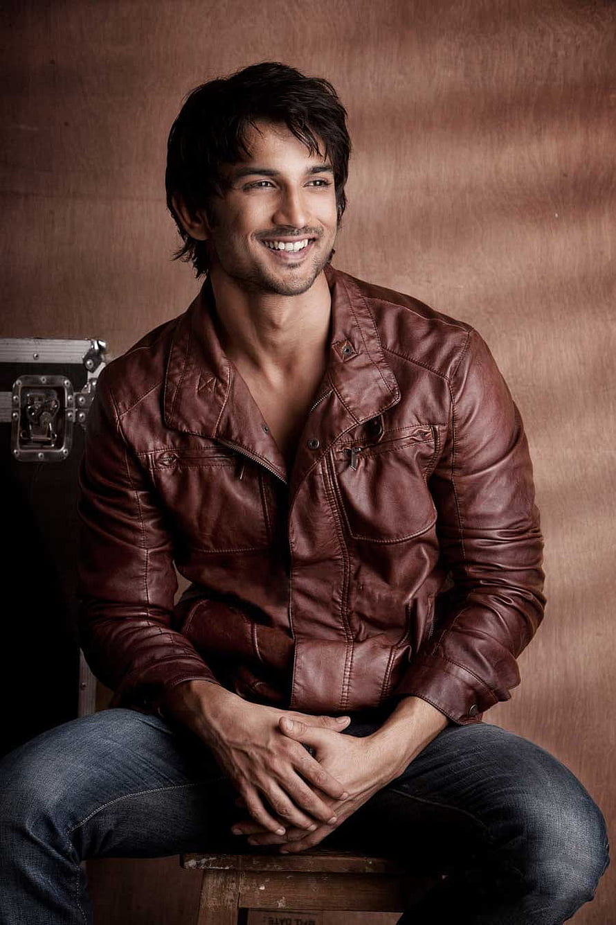 Sushant Singh Rajput in a brown leather jacket and jeans, smiling in a studio portrait HD phone wallpaper