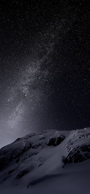 Milky Way Galaxy Arching Over Snow-Covered Mountain Ridge at Night HD phone wallpaper