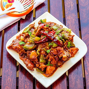 Sizzling Chilli Chicken with Green Peppers and Dried Chilies on a White Plate HD phone wallpaper