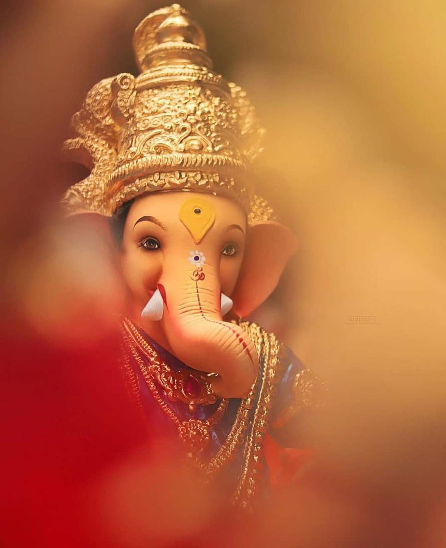 Ganesha Portrait with Golden Crown and Red Garland in Warm Bokeh Light HD phone wallpaper