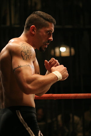 Yuri Boyka in a Focused Boxing Stance Inside a Dark Ring HD phone wallpaper