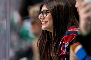 Mia Khalifa Smiling in Profile Wearing Black Glasses and a Red Patterned Sweater HD wallpaper