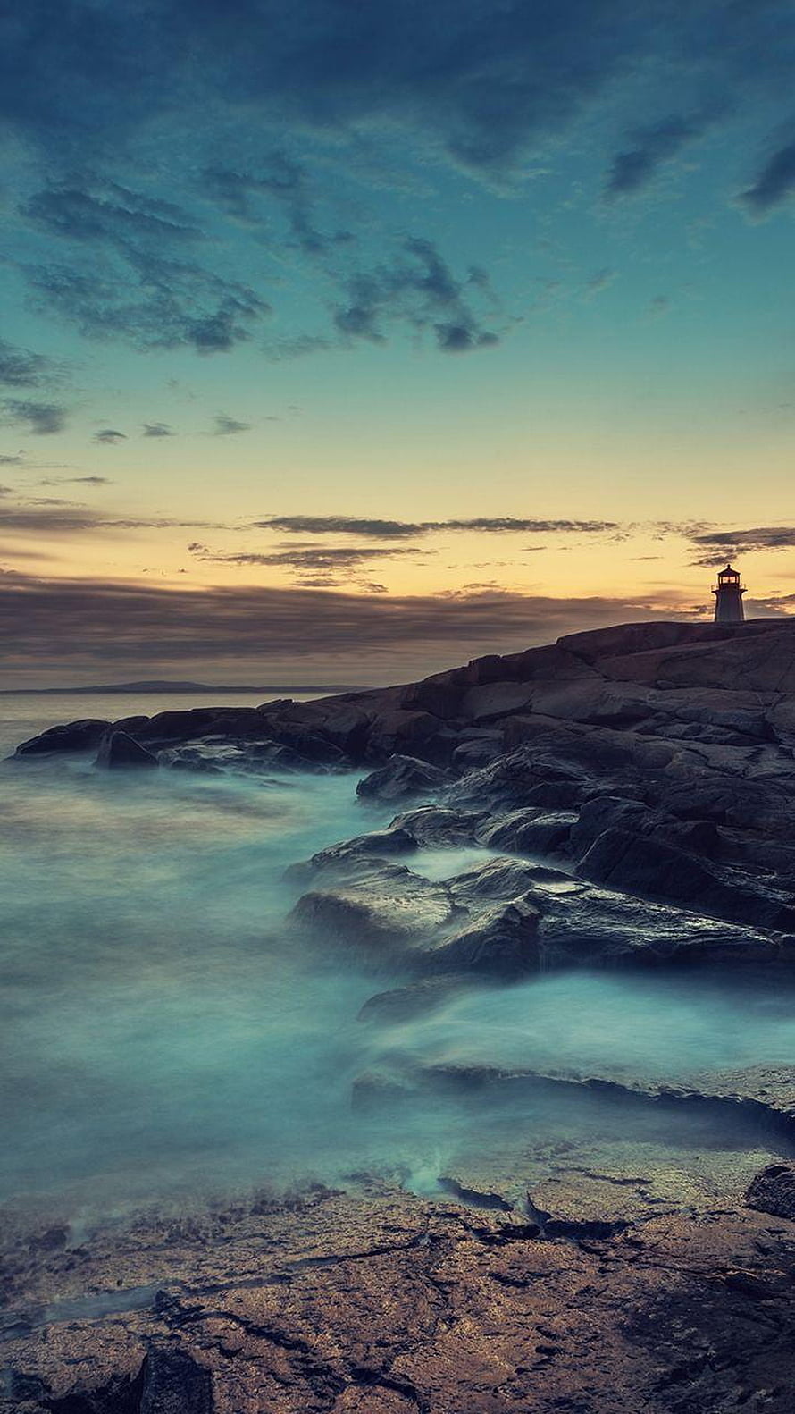 Lighthouse on Rocky Coast at Dusk with Long Exposure Misty Waves HD phone wallpaper