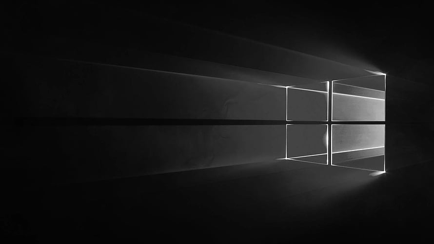Monochrome Windows 10 Logo with Dramatic Light Beams in a Dark Minimalist Setting HD wallpaper