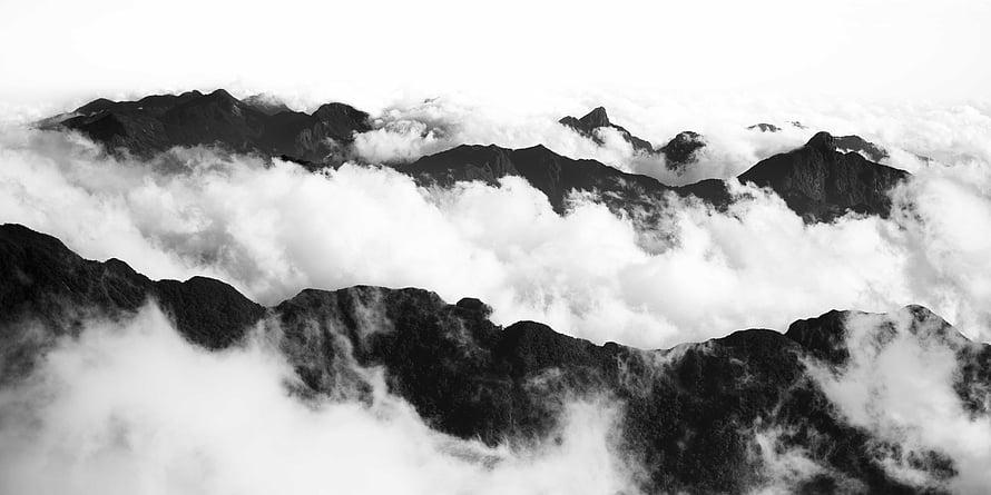 Monochrome Mountain Ranges Emerging Through a Sea of Clouds HD wallpaper