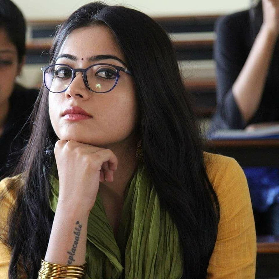 Rashmika Mandanna in a mustard top and green scarf with round glasses HD phone wallpaper