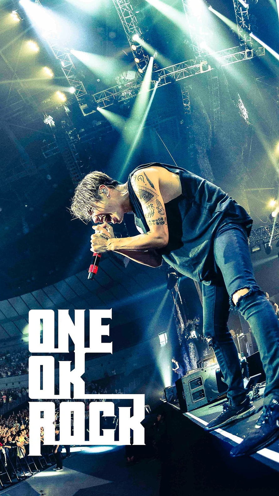 Taka from One Ok Rock performing live on stage with dramatic lighting and microphone HD phone wallpaper