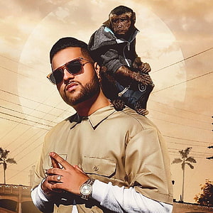 Karan Aujla with a chimpanzee on his shoulders against a golden sky backdrop HD phone wallpaper