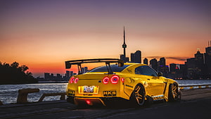 Yellow Nissan GT-R with HKS Widebody Kit Parked on Toronto Waterfront at Sunset HD wallpaper
