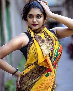 Indian Woman in Vibrant Yellow and Brown Saree with Floral Patterns HD phone wallpaper