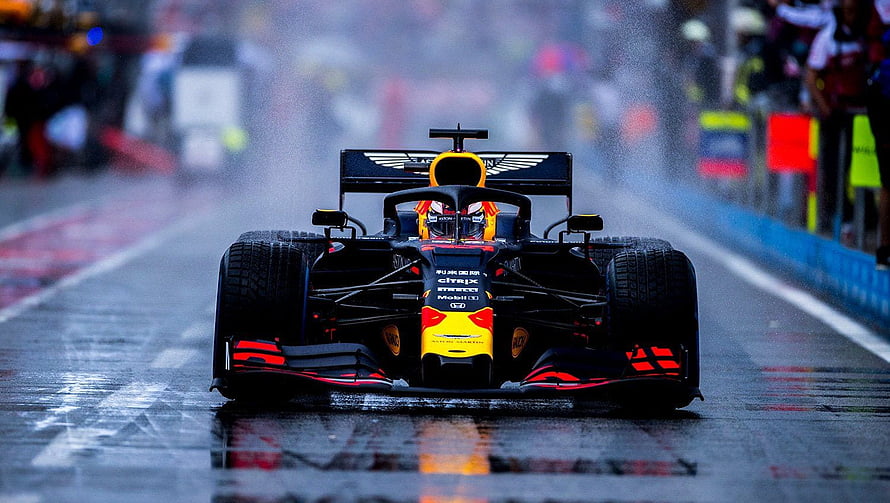 Red Bull Racing Formula 1 car driving on a wet track in the rain HD wallpaper