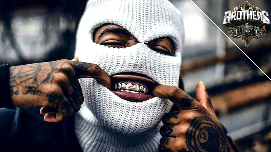 UK Drill Artist in White Knitted Balaclava Showing Gold Grillz and Hand Tattoos HD wallpaper