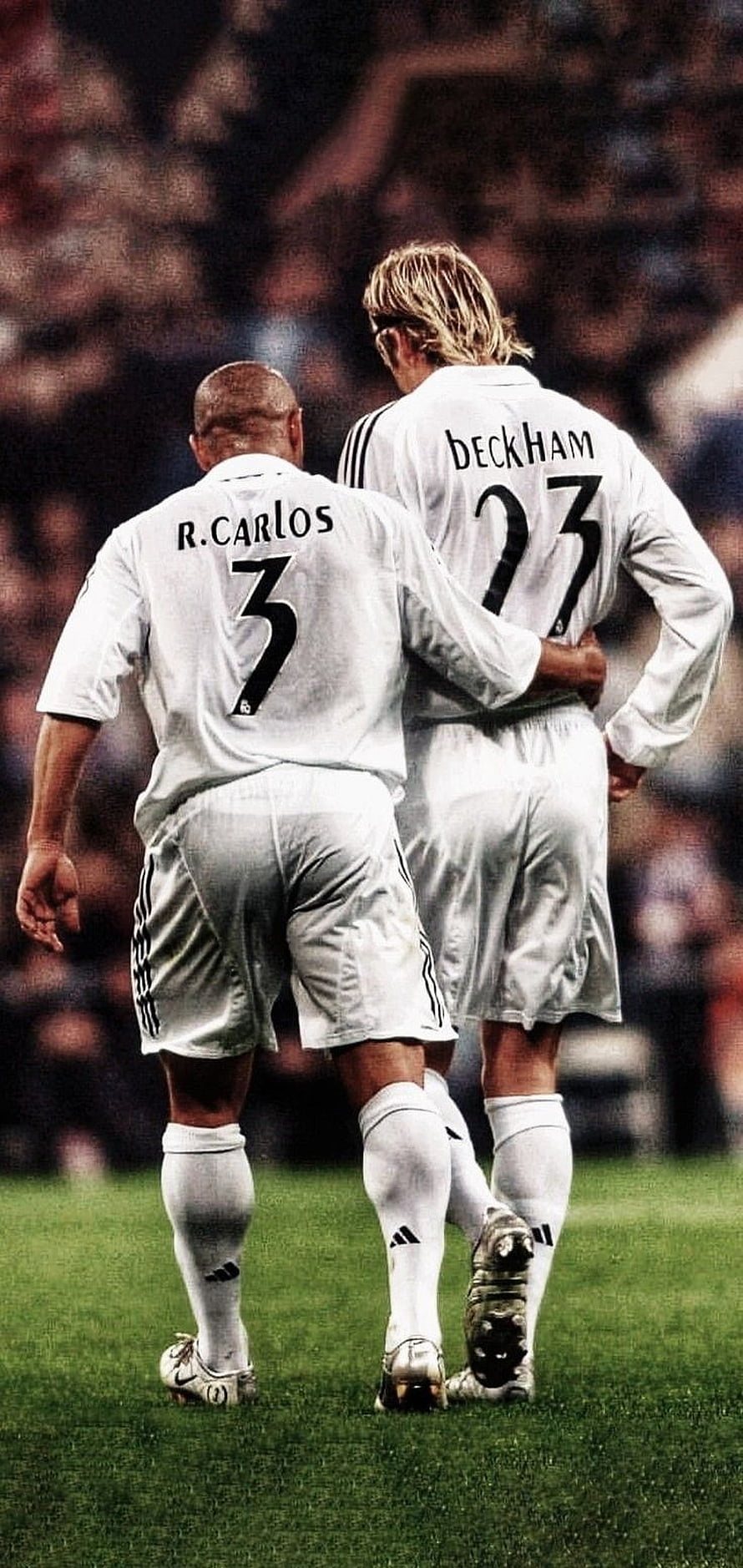 Roberto Carlos and David Beckham in Real Madrid white kits walking on the pitch HD phone wallpaper