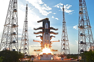 GSLV Mk III rocket launch from ISRO launch pad with service towers and bright engine ignition HD wallpaper