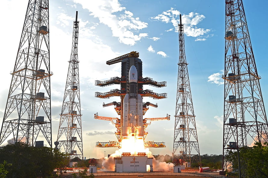 GSLV Mk III rocket launch from ISRO launch pad with service towers and bright engine ignition HD wallpaper