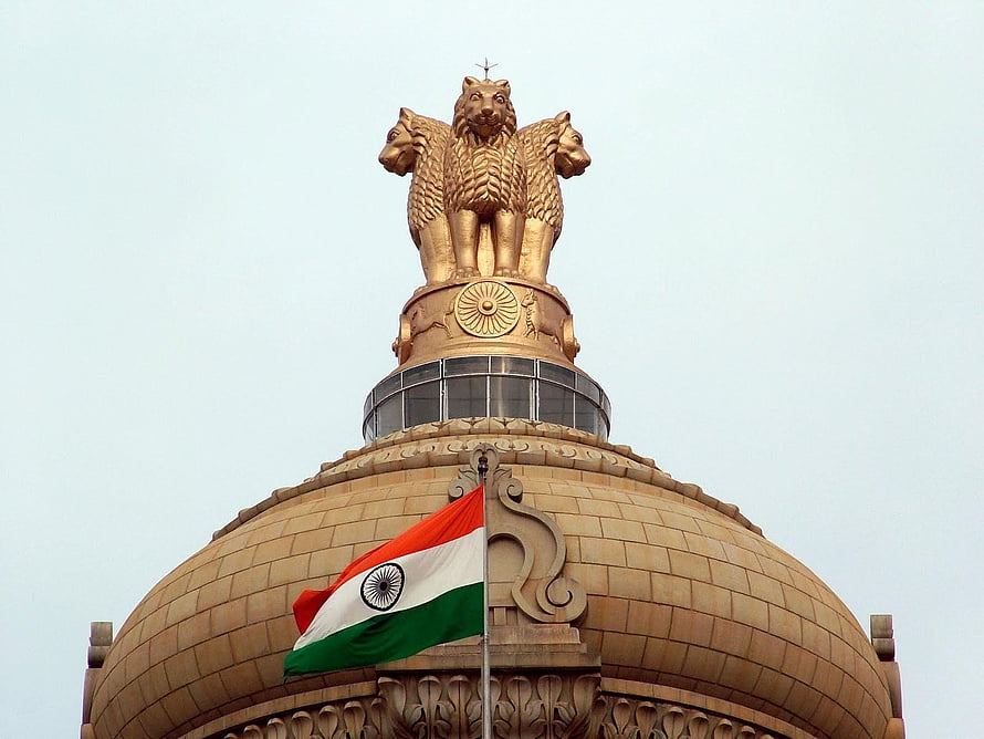 Golden Lion Capital of Ashoka atop the Indian Parliament Building with National Flag HD wallpaper