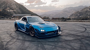 Blue Mazda RX-7 Widebody Drift Car on Mountain Asphalt at Sunset HD wallpaper