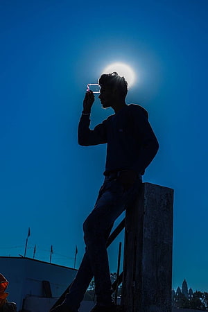 Silhouette of a young man drinking from a glass against a bright sun and deep blue sky, 15 Sad Boy For Whatsapp DP, whatsapp dp boys HD phone wallpaper