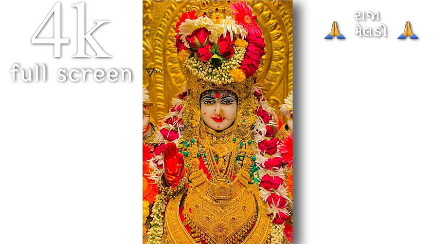 Meldi Maa Divine Idol Adorned With Golden Jewelry And Vibrant Floral Garland HD wallpaper