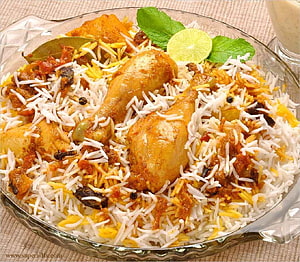 Chicken Biryani with Saffron Rice, Mint Leaves, and Lime Garnish in a Glass Serving Dish HD wallpaper