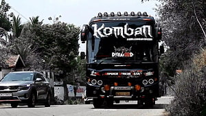Komban Dawood Tourist Bus Front View on a Suburban Road HD wallpaper