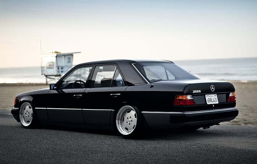 Black Mercedes-Benz W124 300E Stance Build Parked on Beach Asphalt HD wallpaper